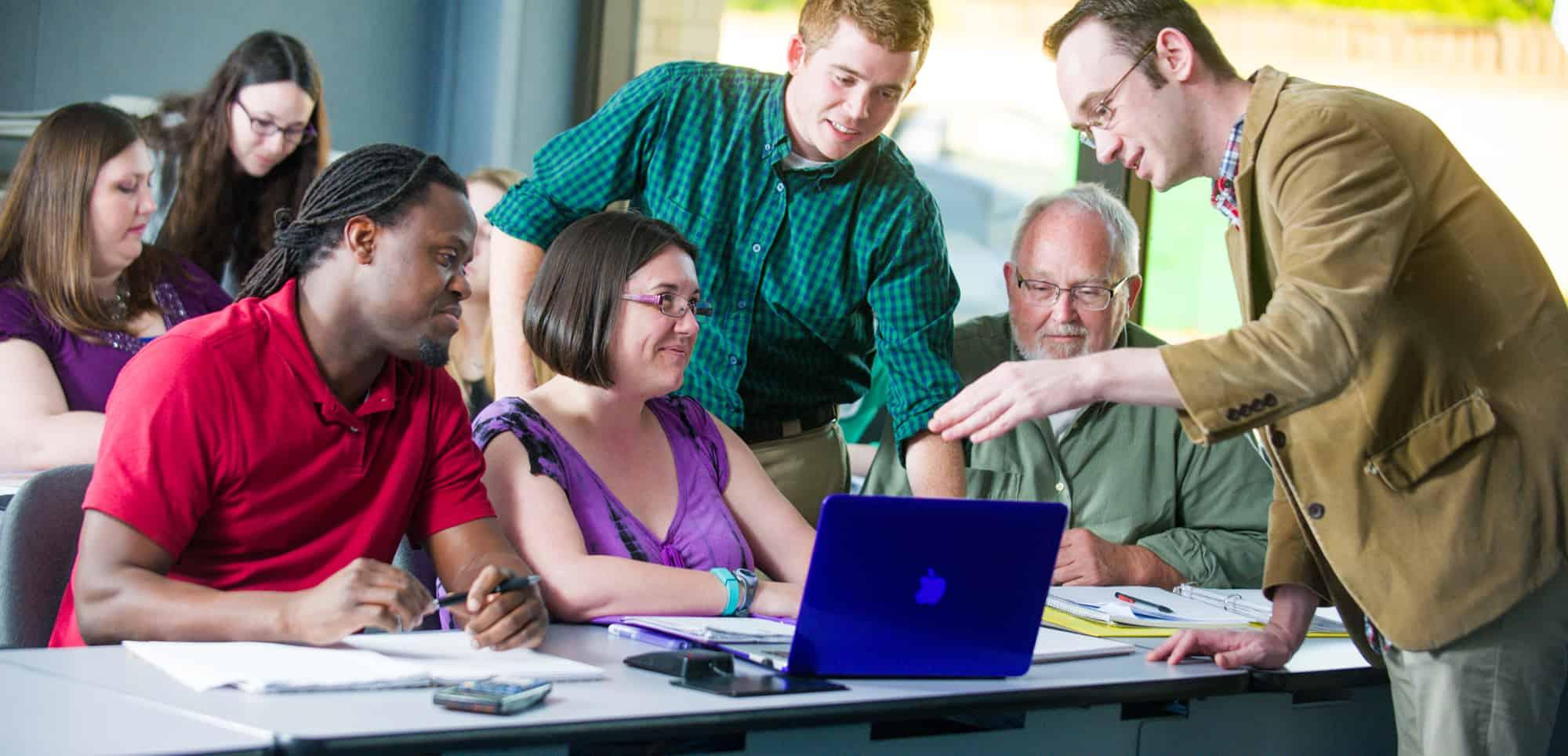 Professor actively engaged in a conversation with a student.