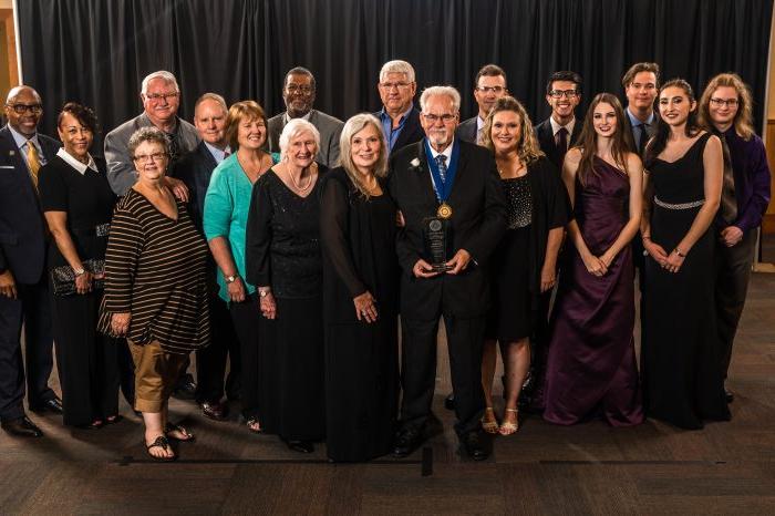 Student and faculty receiving an award.