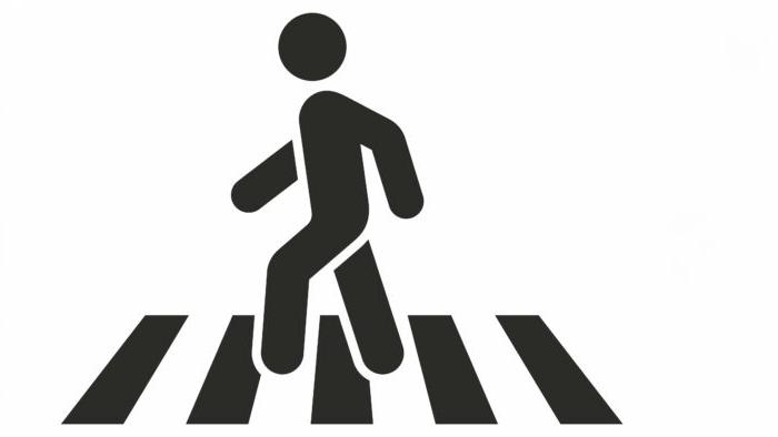 Black and white illustration shows a stick person crossing a crosswalk.