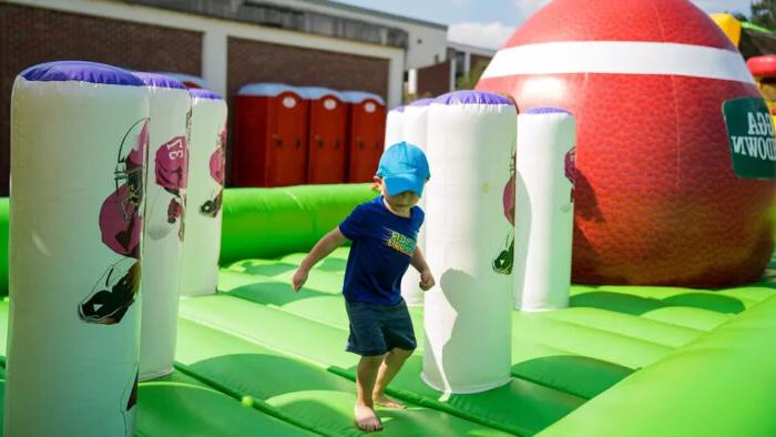 A child playing on an inflatable play space.